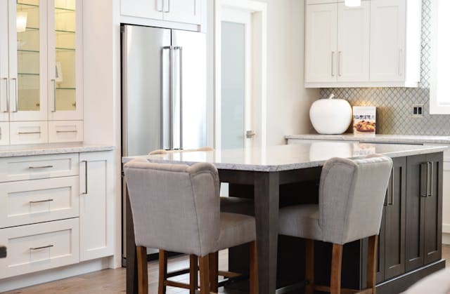 white and metal kitchen with grey chairs at table